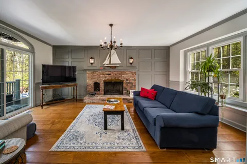 a living room with furniture flat screen tv and a fireplace