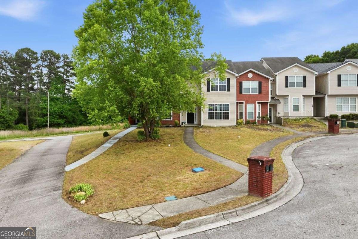 166 Odyssey Conyers, GA 30012 - Photo 1 of 42 a view of a white house with a swimming pool