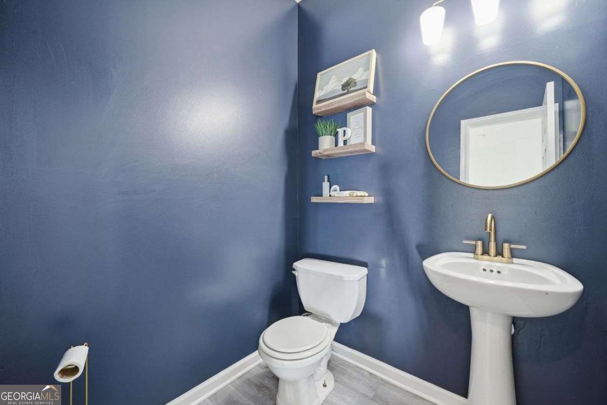 166 Odyssey Conyers, GA 30012 - Photo 19 of 42 a bathroom with a toilet sink and mirror