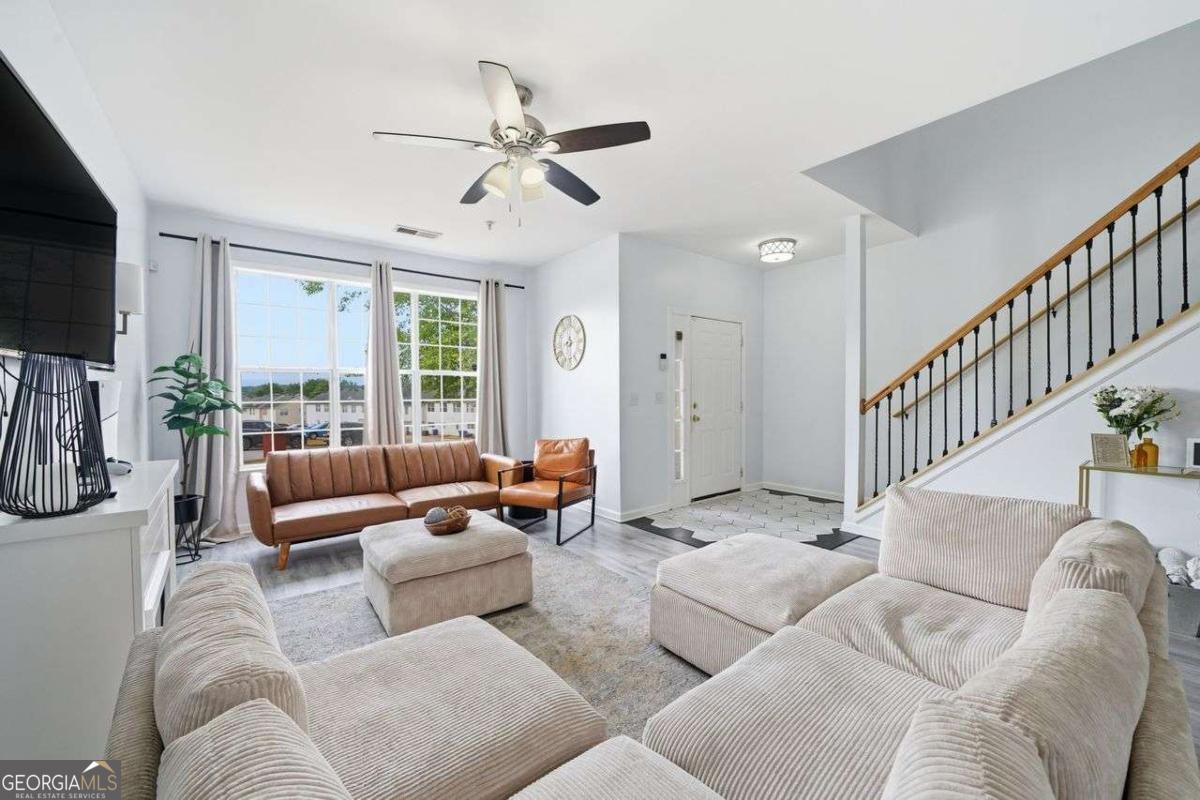 166 Odyssey Conyers, GA 30012 - Photo 2 of 42 a living room with furniture ceiling fan and a flat screen tv
