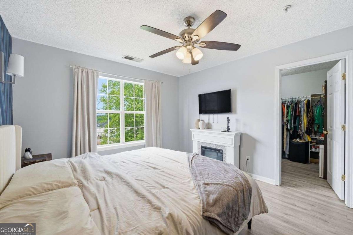 166 Odyssey Conyers, GA 30012 - Photo 24 of 42 a bedroom with a large bed and a flat tv screen