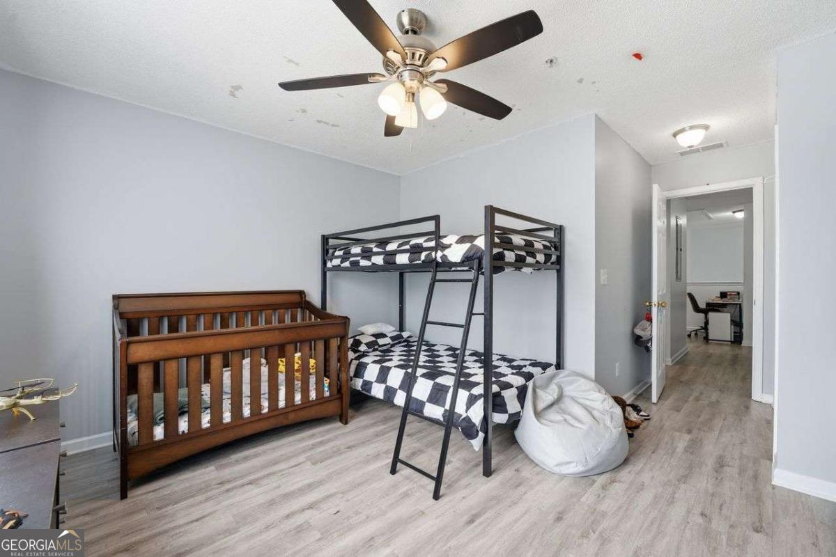 166 Odyssey Conyers, GA 30012 - Photo 27 of 42 a bedroom with furniture and wooden floor