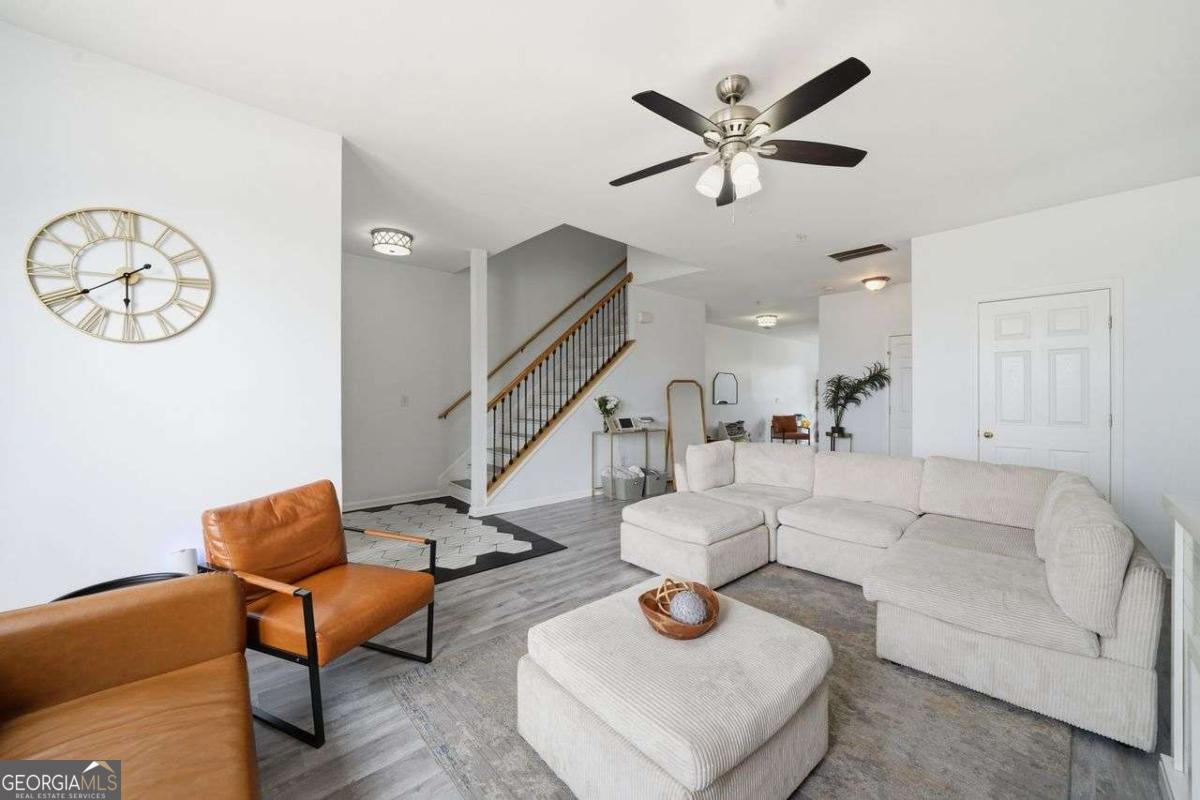 166 Odyssey Conyers, GA 30012 - Photo 6 of 42 a living room with furniture and a clock