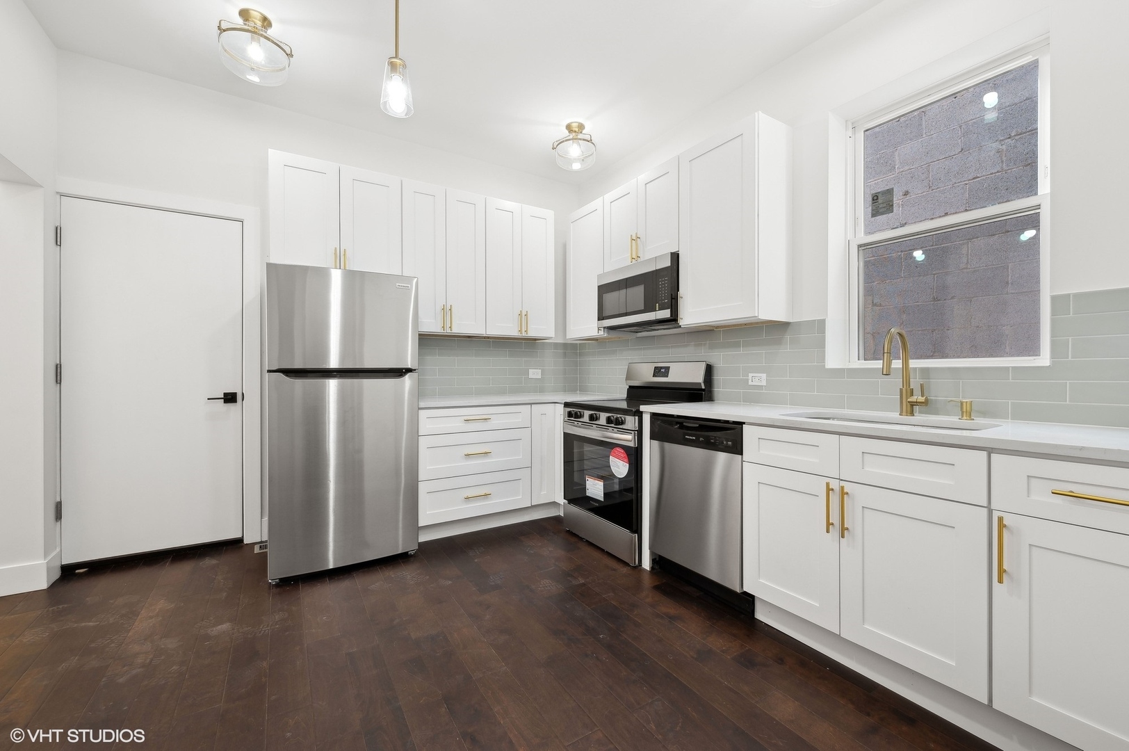 2313 West Fullerton Avenue Chicago, IL 60647 - Photo 11 of 25 a kitchen with stainless steel appliances a refrigerator sink and microwave