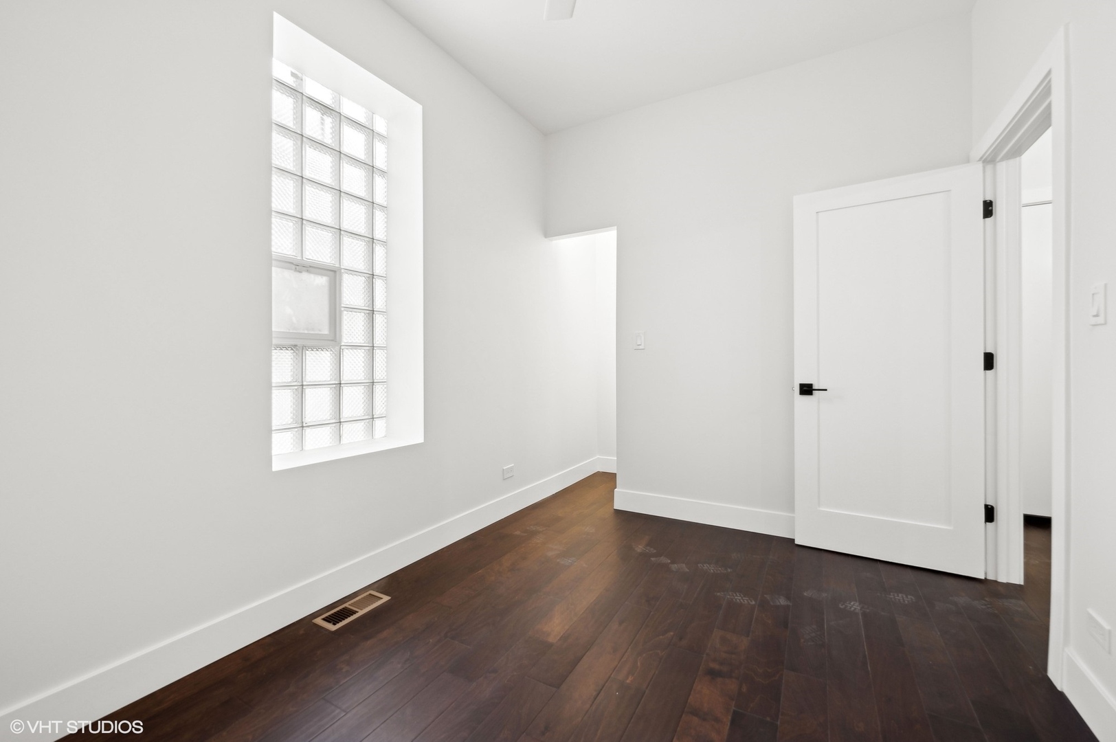 2313 West Fullerton Avenue Chicago, IL 60647 - Photo 13 of 25 an empty room with wooden floor and windows