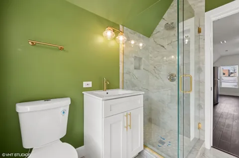 a bathroom with a toilet sink and shower