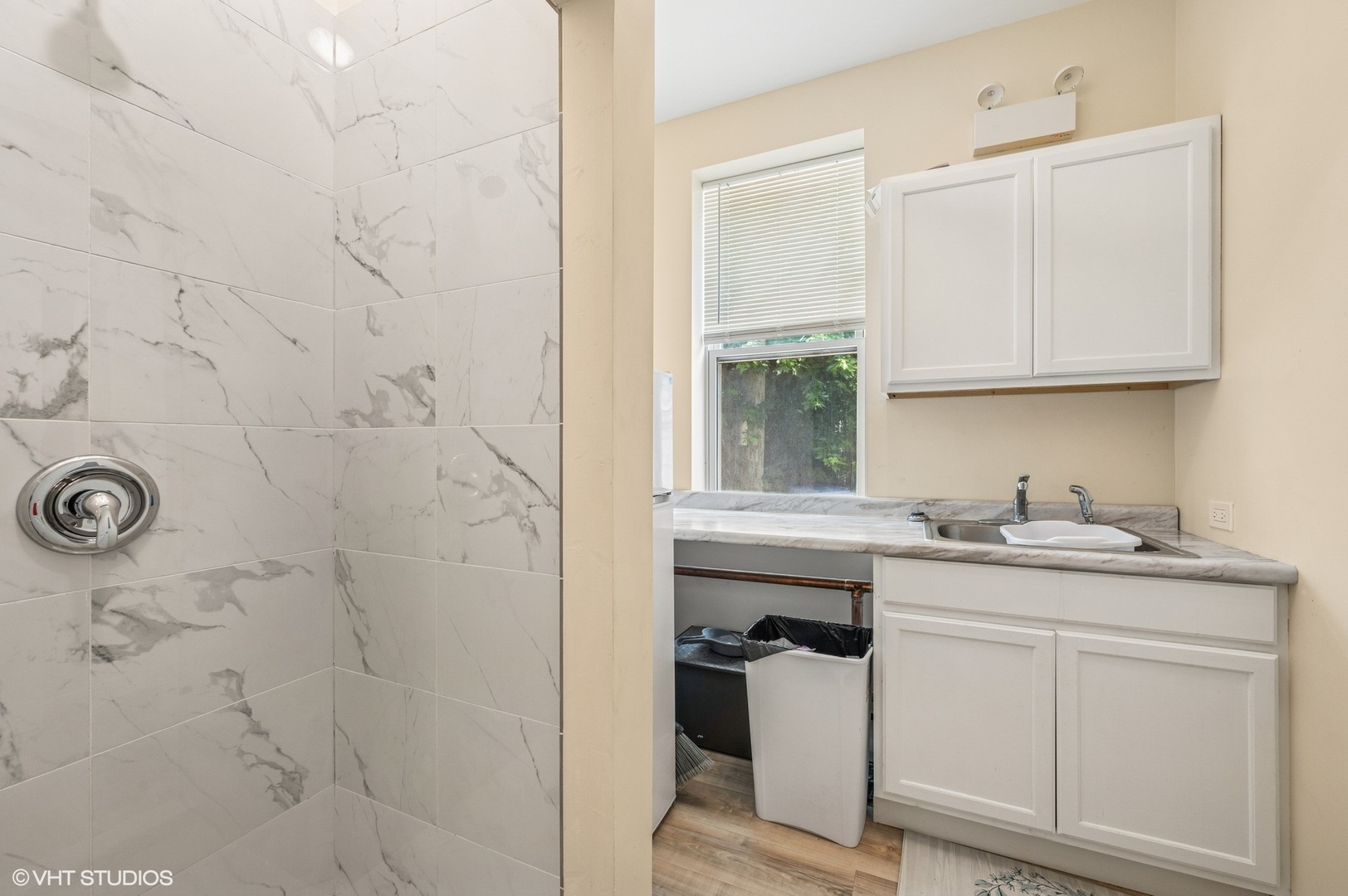 2313 West Fullerton Avenue Chicago, IL 60647 - Photo 9 of 25 a bathroom with a granite countertop sink a window and vanity