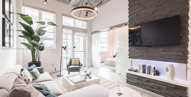 a living room with furniture and a large window