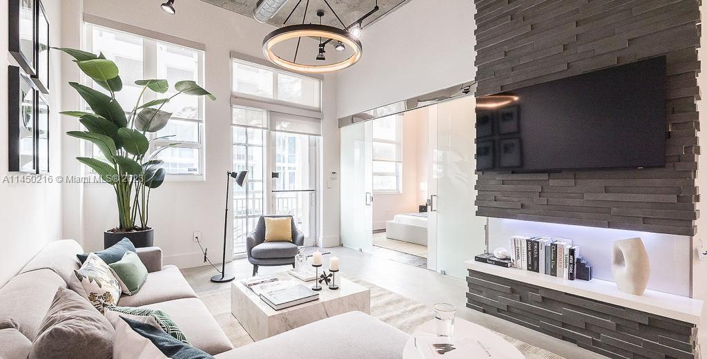 2001 Biscayne Boulevard, Unit 2104 Miami, FL 33137 - Photo 1 of 17 a living room with furniture and a large window