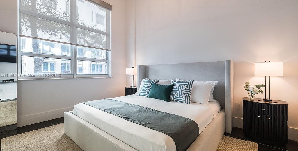 2001 Biscayne Boulevard, Unit 2104 Miami, FL 33137 - Photo 11 of 17 a bedroom with a bed and a window