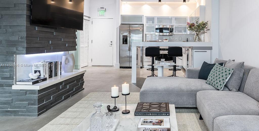 2001 Biscayne Boulevard, Unit 2104 Miami, FL 33137 - Photo 3 of 17 a living room with furniture and a fireplace