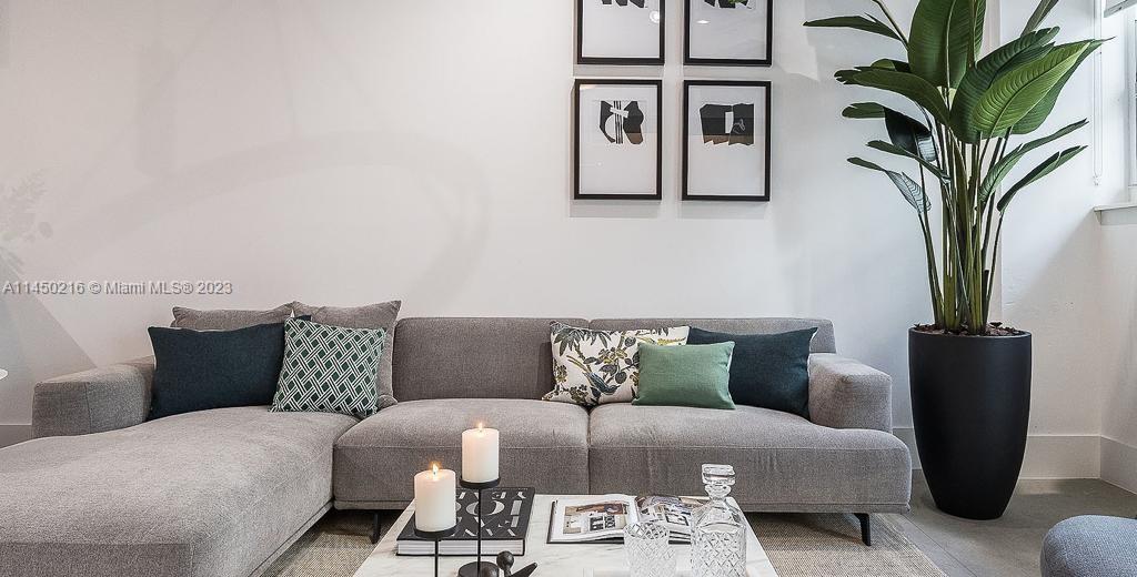 2001 Biscayne Boulevard, Unit 2104 Miami, FL 33137 - Photo 4 of 17 a bedroom with furniture and a potted plant