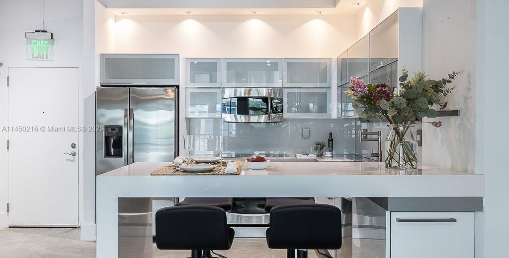 2001 Biscayne Boulevard, Unit 2104 Miami, FL 33137 - Photo 5 of 17 a kitchen with a sink cabinets and window