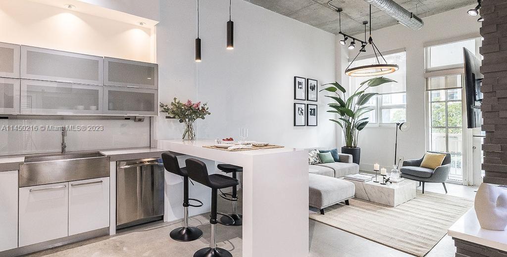 2001 Biscayne Boulevard, Unit 2104 Miami, FL 33137 - Photo 6 of 17 a kitchen with a table and chairs