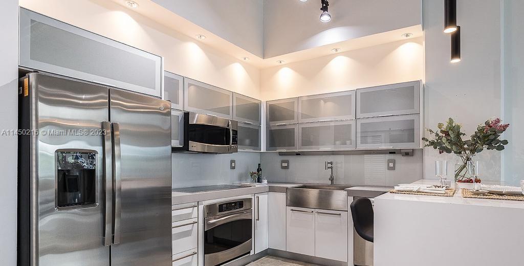 2001 Biscayne Boulevard, Unit 2104 Miami, FL 33137 - Photo 7 of 17 a kitchen with a sink and refrigerator
