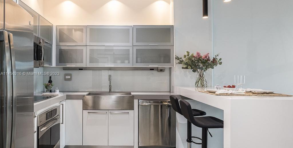 2001 Biscayne Boulevard, Unit 2104 Miami, FL 33137 - Photo 8 of 17 a kitchen with a sink and cabinets