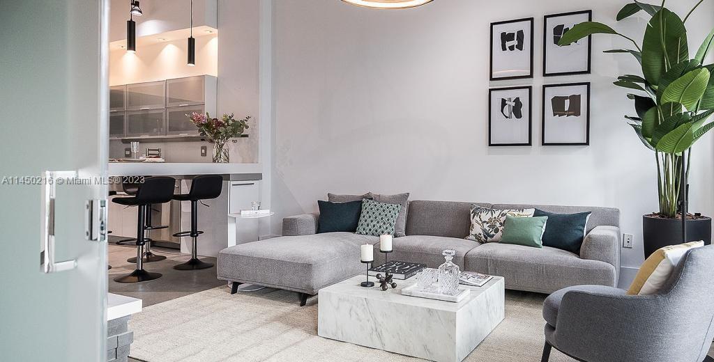 2001 Biscayne Boulevard, Unit 2104 Miami, FL 33137 - Photo 9 of 17 a living room with furniture and a potted plant