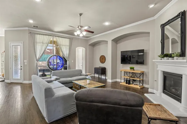 a living room with furniture a fireplace and a flat screen tv
