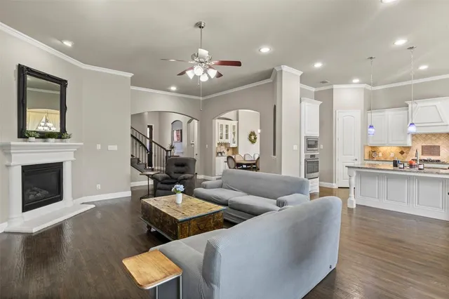 a living room with furniture kitchen view and a fireplace
