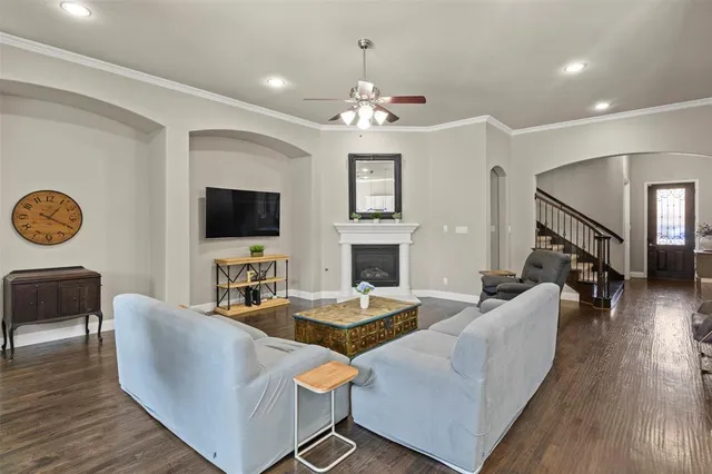a living room with fireplace furniture and a flat screen tv