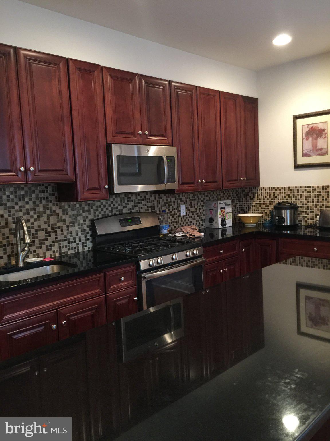 4080 Spring Garden Street Philadelphia, PA 19104 - Photo 19 of 28 Modern kitchen with rich wood accents.