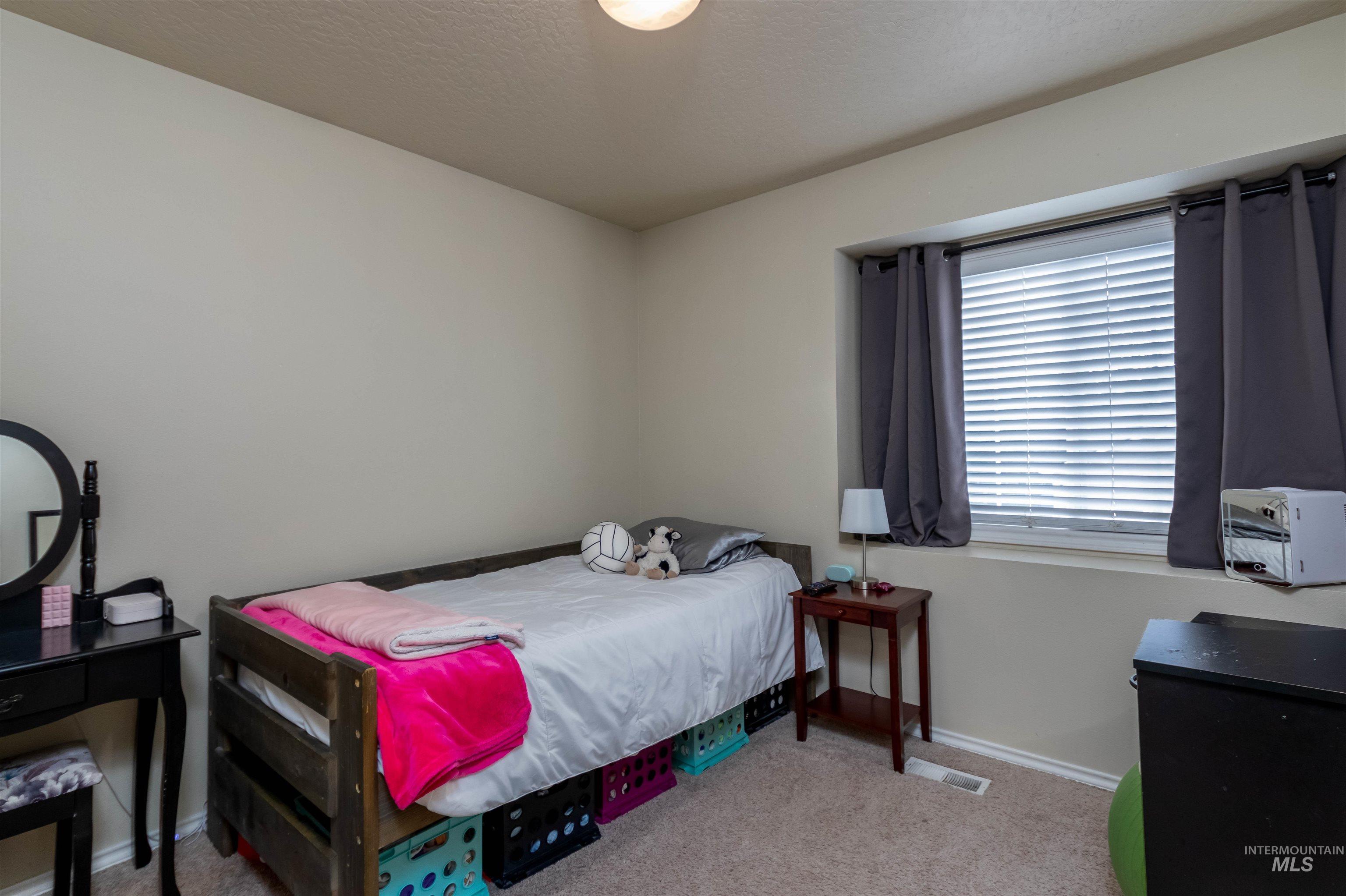 485 North Nebula Avenue Star, ID 83669 - Photo 15 of 47 Carpeted bedroom featuring baseboards and a textured ceiling