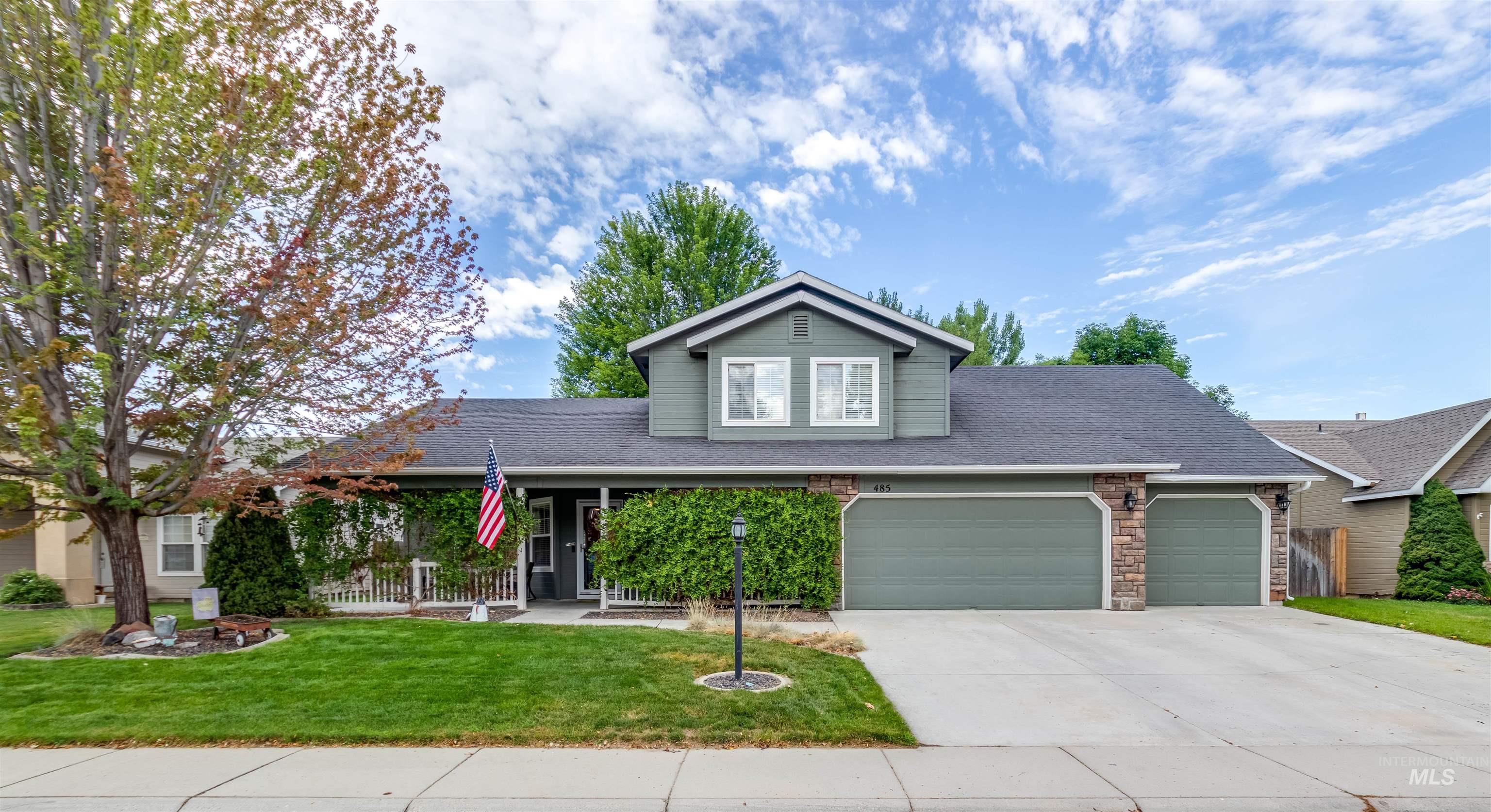 485 North Nebula Avenue Star, ID 83669 - Photo 24 of 47 Traditional-style house with a shingled roof, a front lawn, a garage, concrete driveway, and stone siding