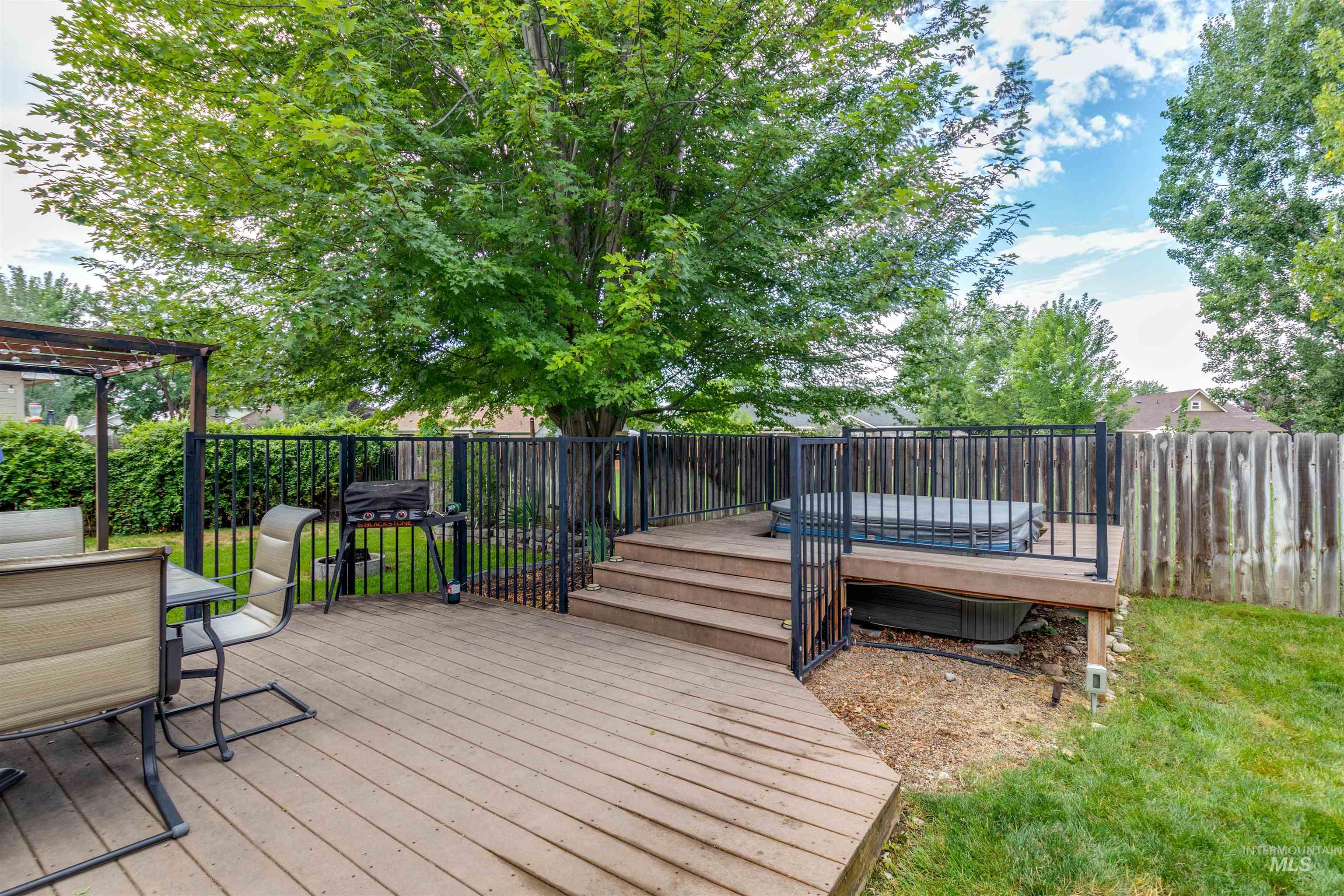 485 North Nebula Avenue Star, ID 83669 - Photo 34 of 47 Wooden deck with outdoor dining space and a fenced backyard