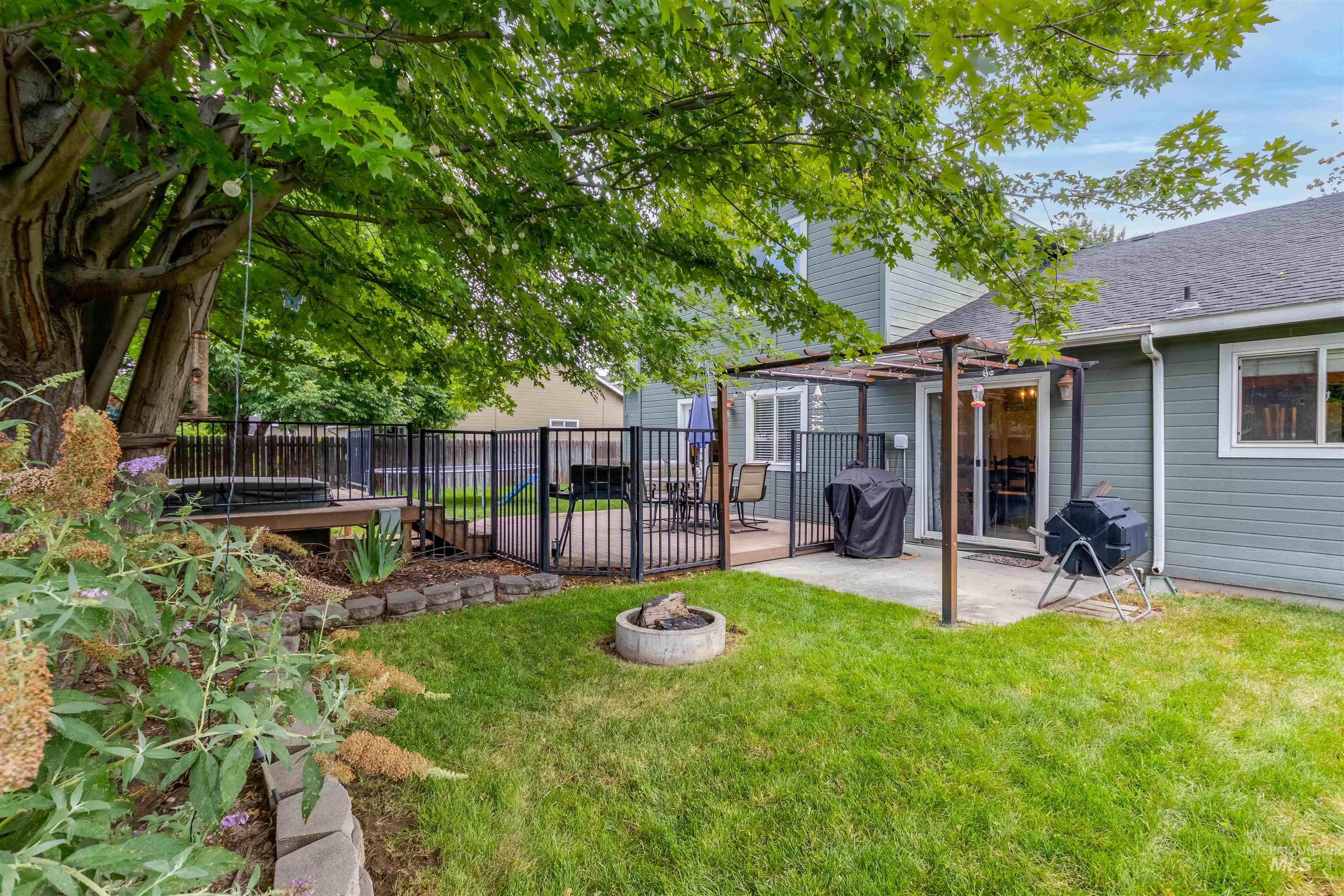 485 North Nebula Avenue Star, ID 83669 - Photo 36 of 47 Fenced backyard with a fire pit, a patio, and a pergola