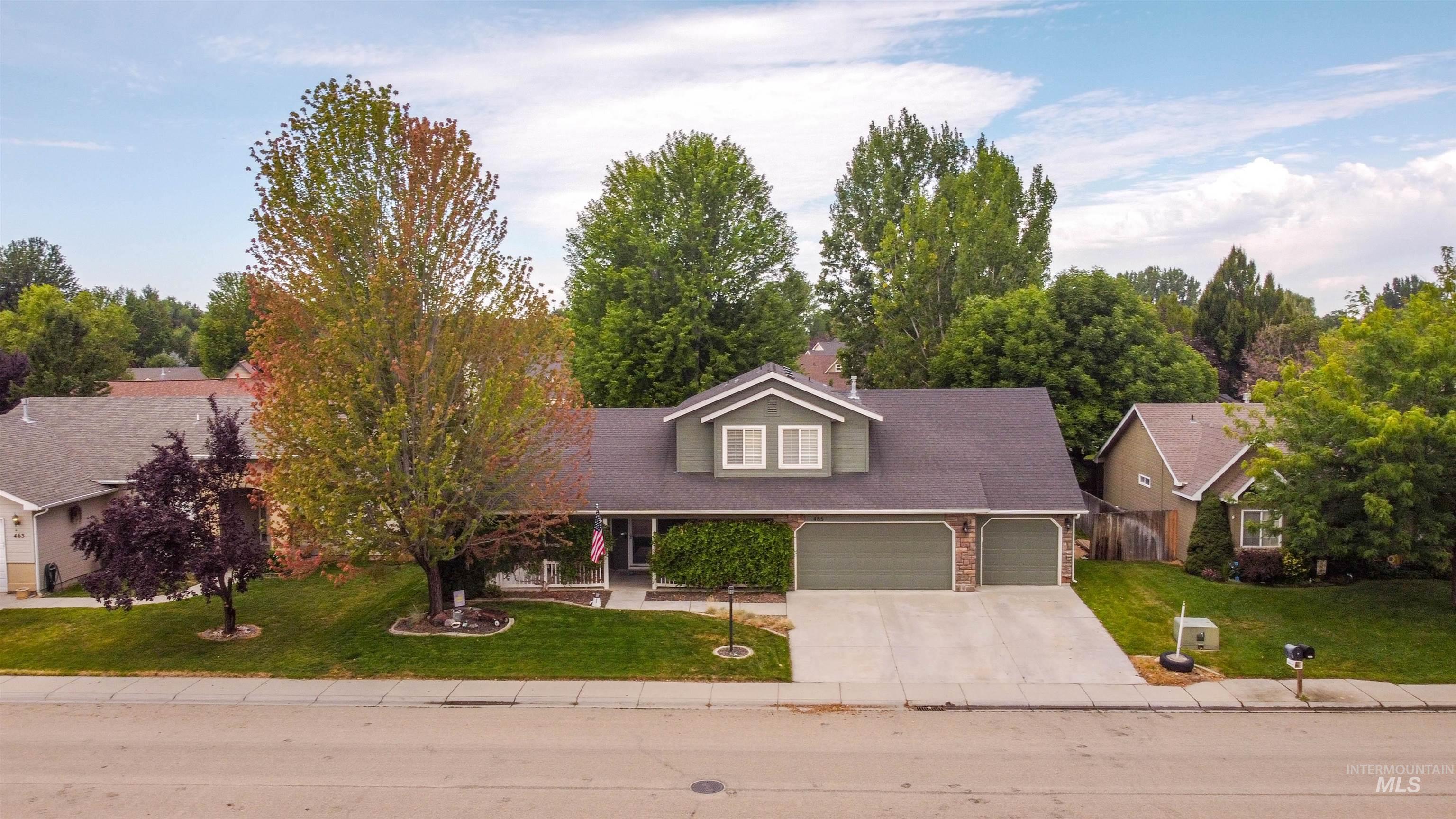 485 North Nebula Avenue Star, ID 83669 - Photo 38 of 47 View of front facade with a garage, a front yard, driveway, and brick siding