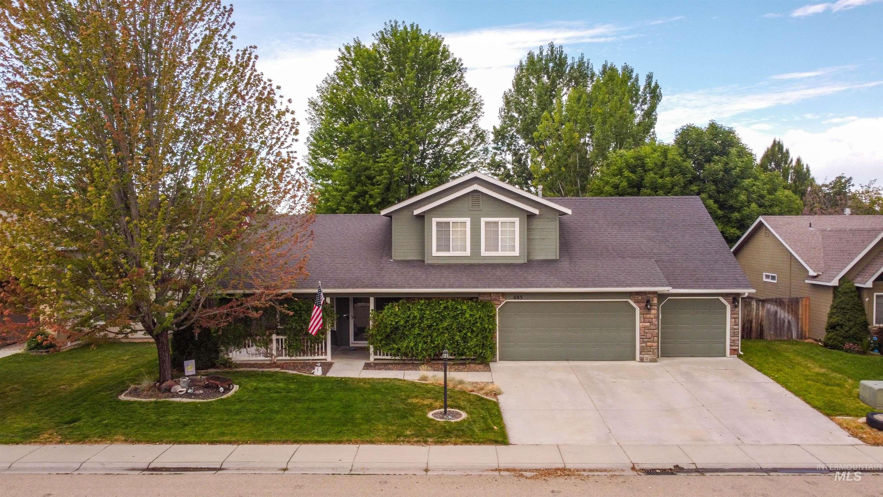 485 North Nebula Avenue Star, ID 83669 - Photo 39 of 47 View of front of home featuring an attached garage, roof with shingles, concrete driveway, and stone siding