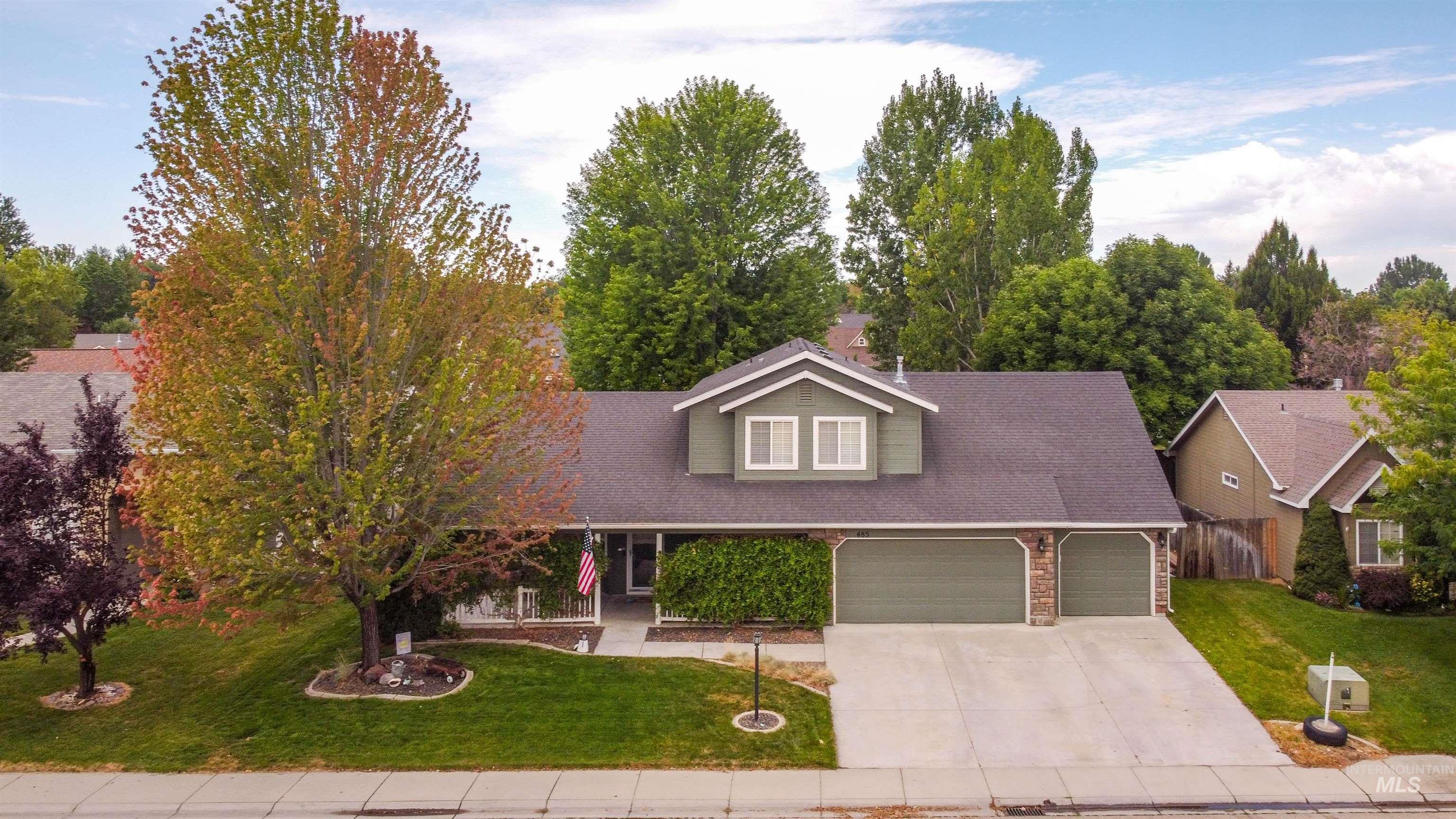 485 North Nebula Avenue Star, ID 83669 - Photo 42 of 47 View of front facade featuring a garage, a front yard, driveway, and roof with shingles
