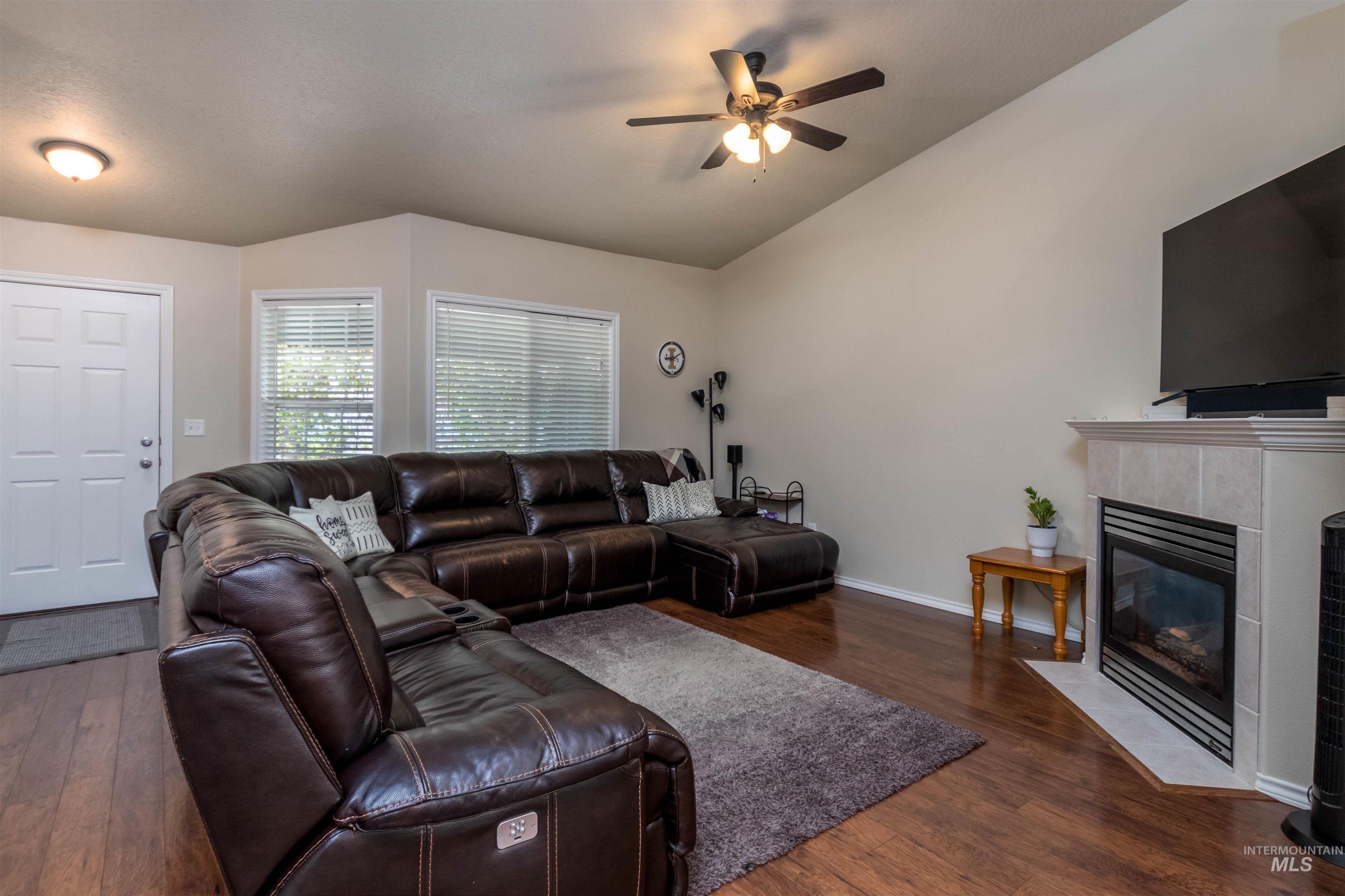 485 North Nebula Avenue Star, ID 83669 - Photo 5 of 47 Living room with hardwood / wood-style floors, ceiling fan, a fireplace, and lofted ceiling