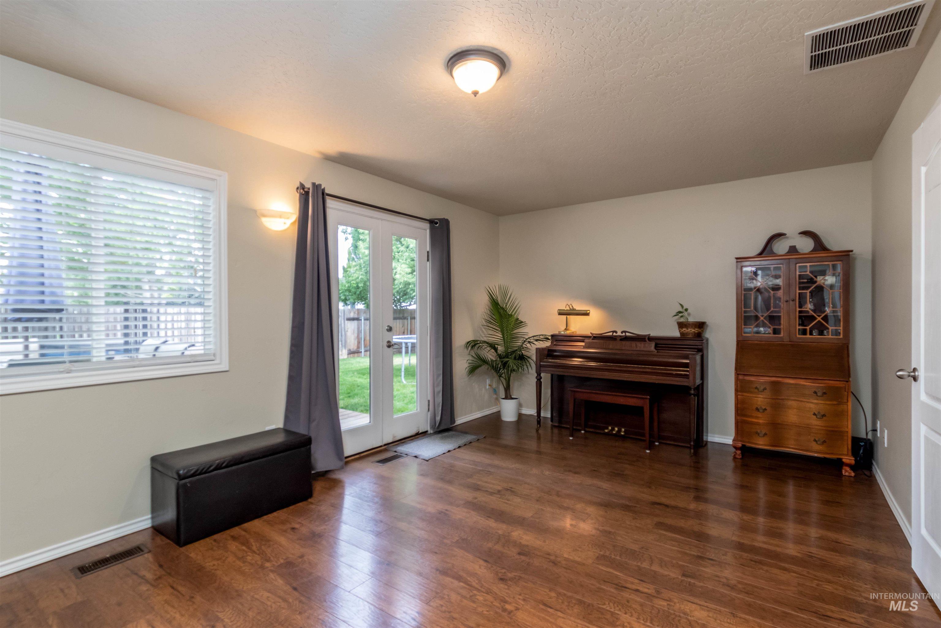 485 North Nebula Avenue Star, ID 83669 - Photo 10 of 47 Living area with wood finished floors and a textured ceiling