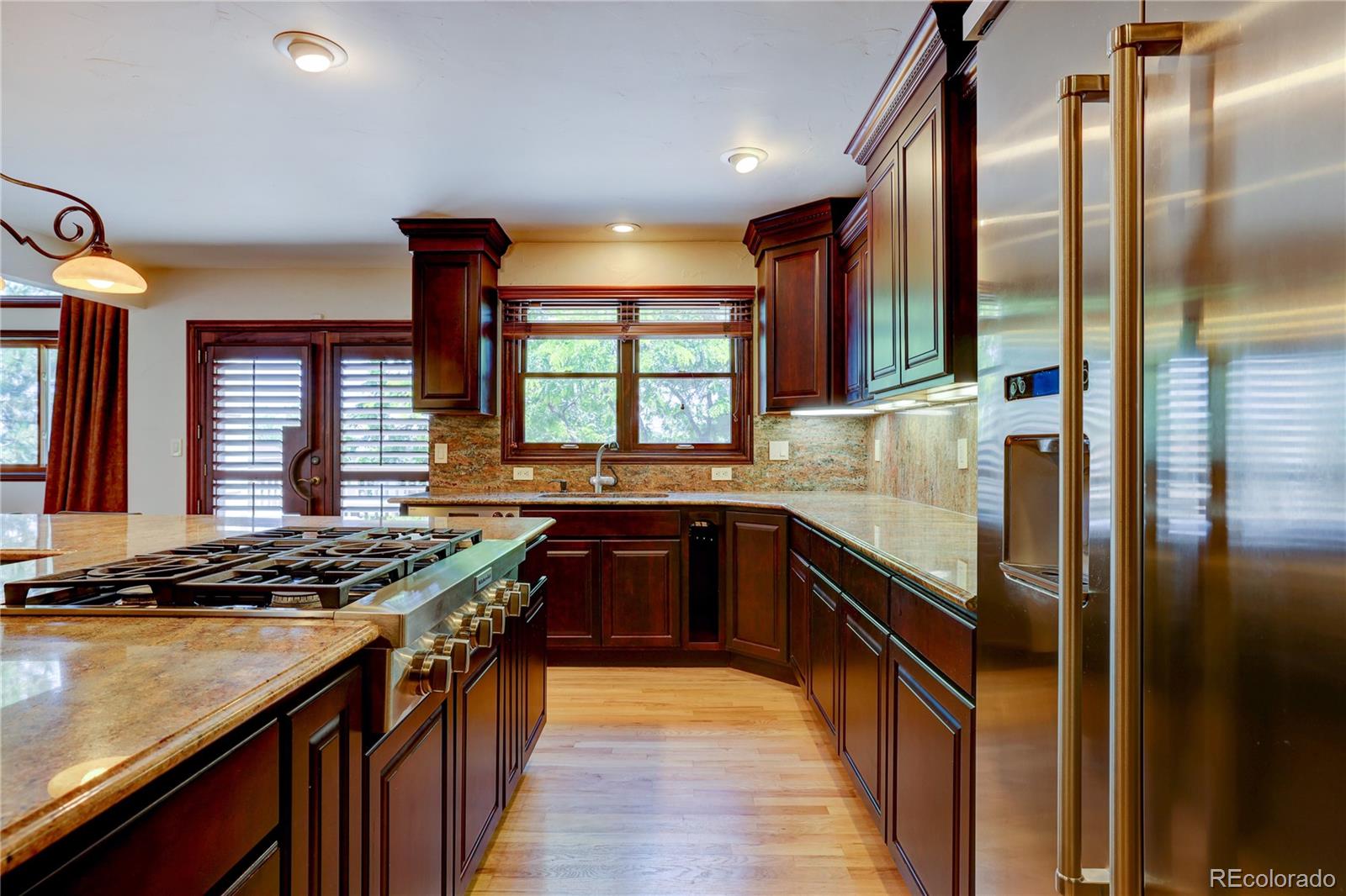 8844 South Forrest Drive Highlands Ranch, CO 80126 - Photo 15 of 40 a kitchen with stainless steel appliances granite countertop a sink and a stove