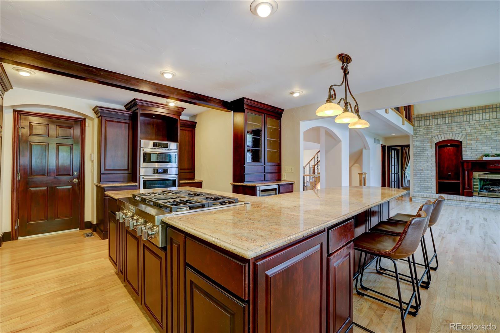 8844 South Forrest Drive Highlands Ranch, CO 80126 - Photo 16 of 40 a kitchen that has a sink a stove and a table