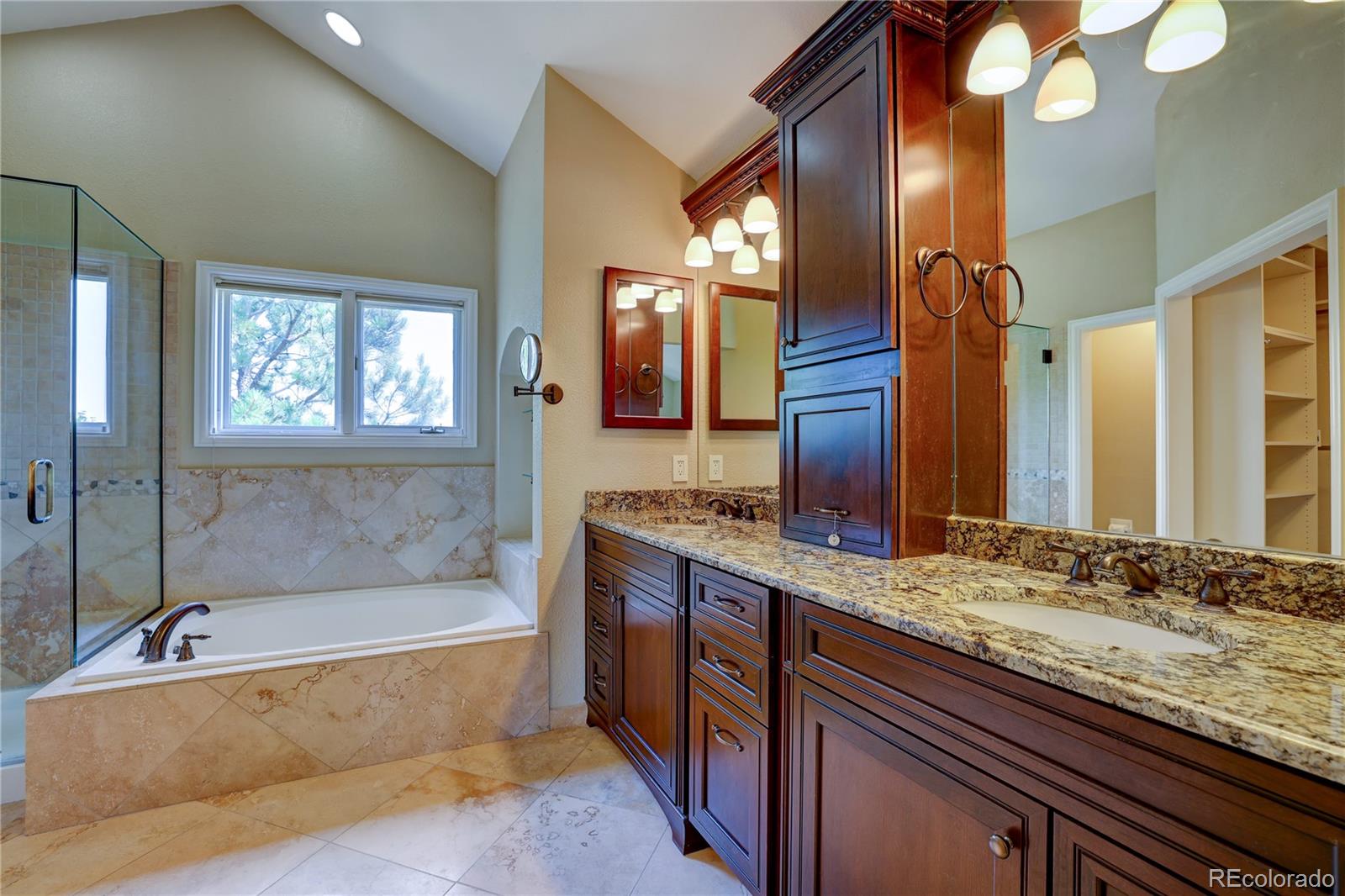 8844 South Forrest Drive Highlands Ranch, CO 80126 - Photo 18 of 40 a bathroom with a bathtub and a double vanity sink mirror