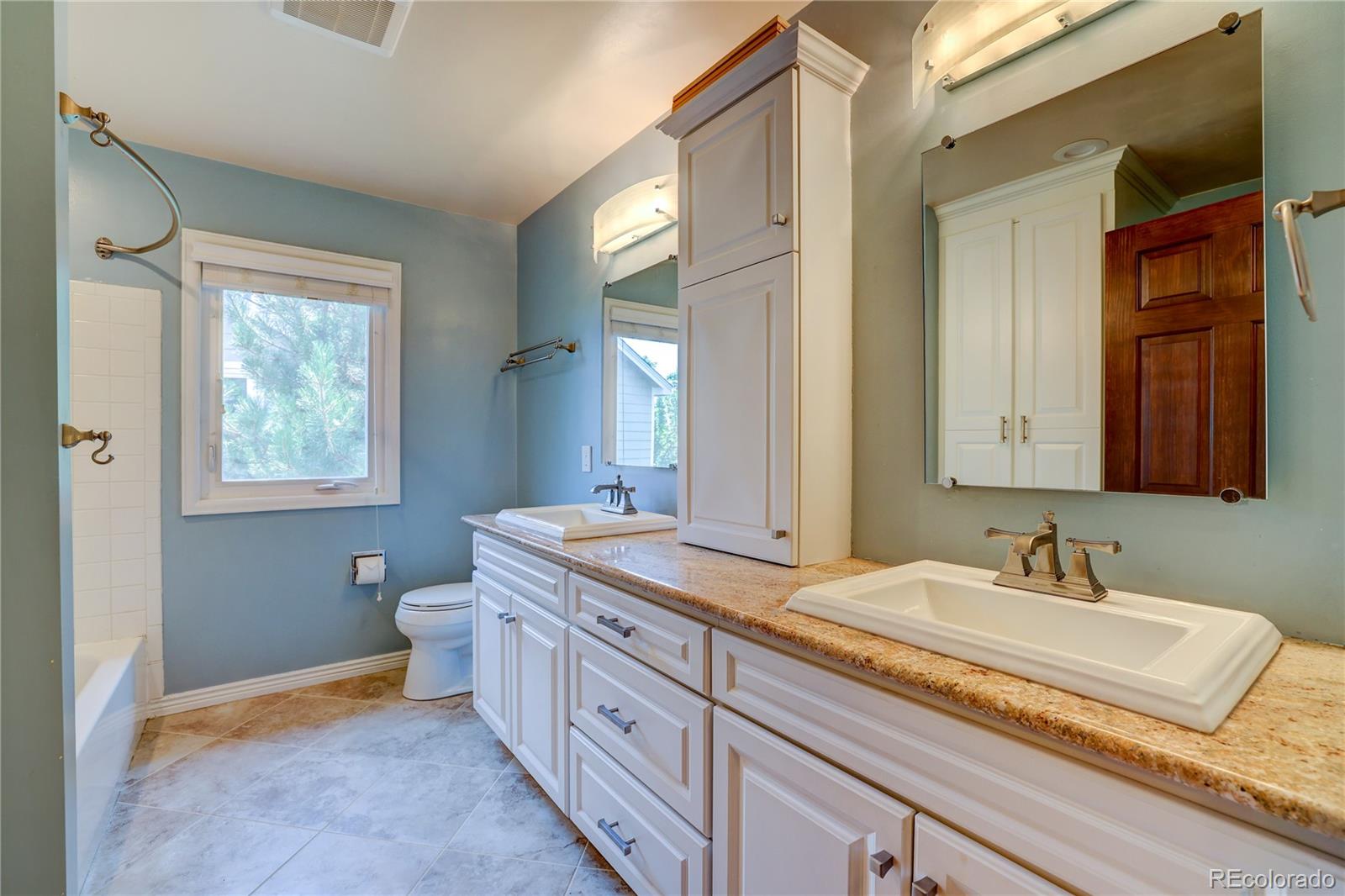 8844 South Forrest Drive Highlands Ranch, CO 80126 - Photo 20 of 40 a bathroom with a granite countertop sink mirror and a toilet