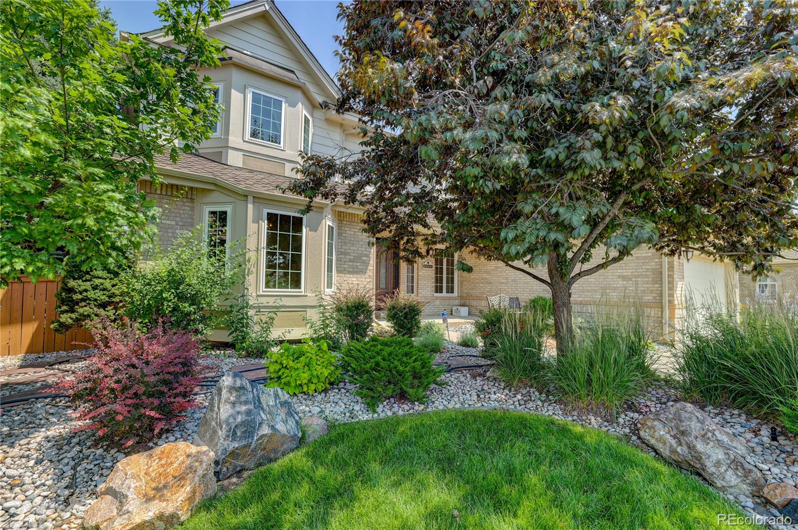 8844 South Forrest Drive Highlands Ranch, CO 80126 - Photo 2 of 40 a front view of a house with garden