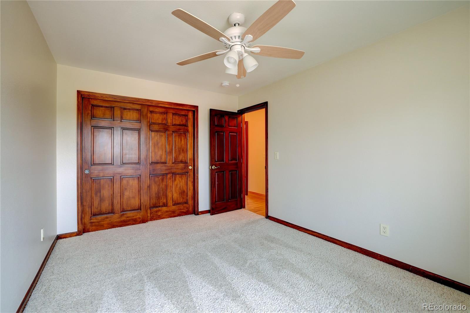 8844 South Forrest Drive Highlands Ranch, CO 80126 - Photo 21 of 40 a view of an empty room with cabinet and a ceiling fan