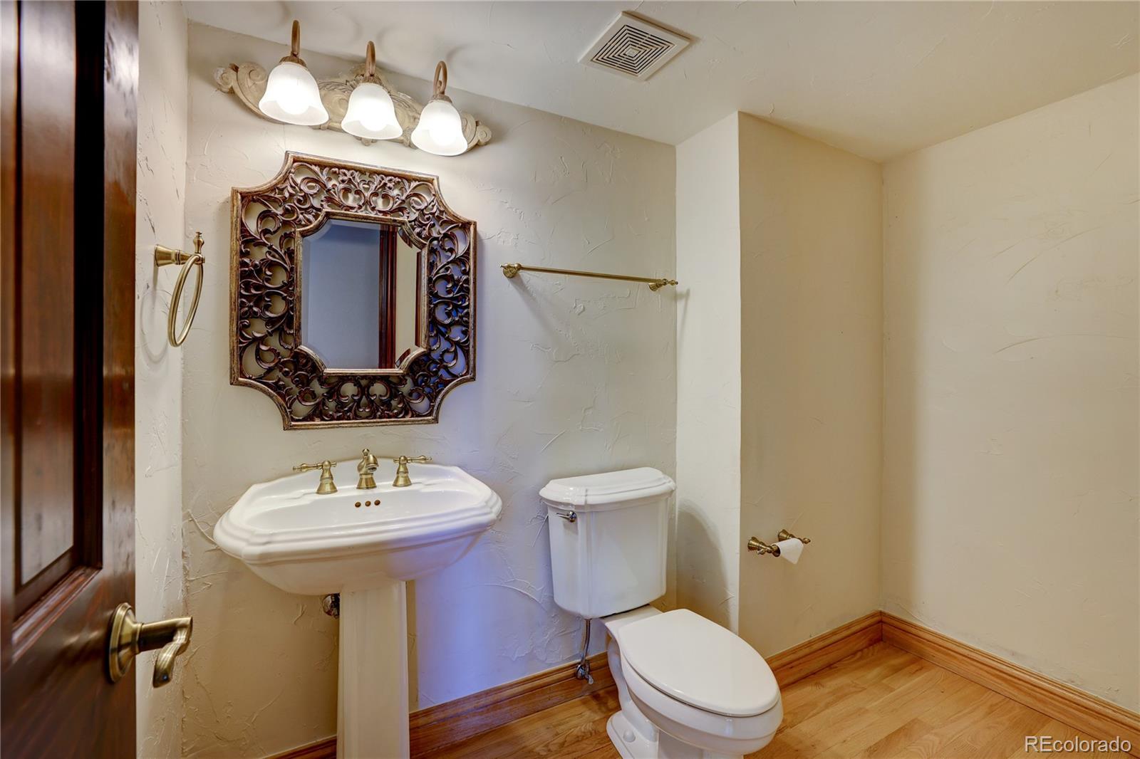 8844 South Forrest Drive Highlands Ranch, CO 80126 - Photo 22 of 40 a bathroom with a sink and a mirror