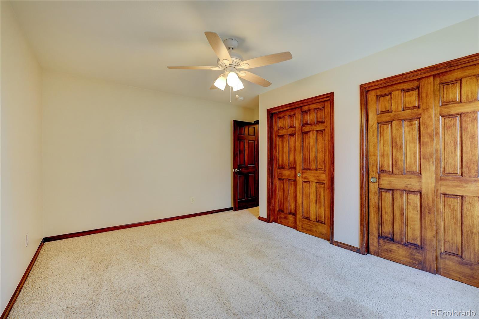 8844 South Forrest Drive Highlands Ranch, CO 80126 - Photo 23 of 40 a view of an empty room with a ceiling fan