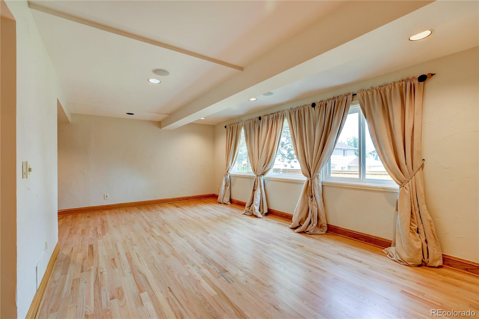 8844 South Forrest Drive Highlands Ranch, CO 80126 - Photo 25 of 40 an empty room with wooden floor and windows