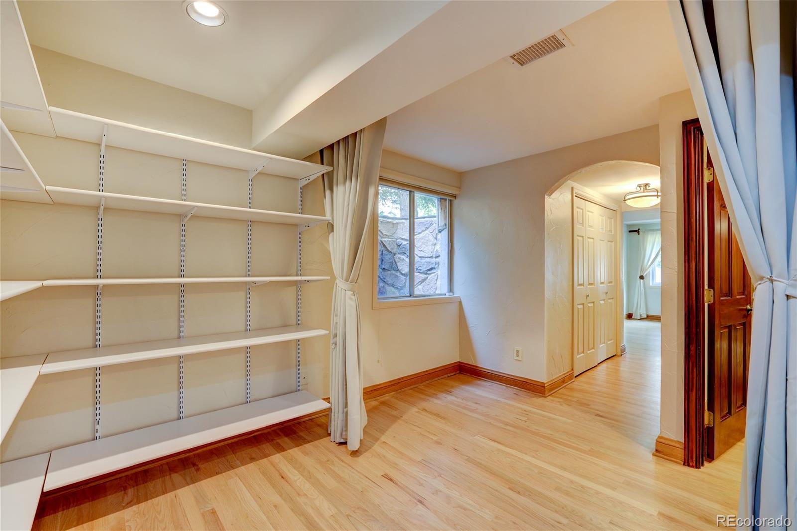 8844 South Forrest Drive Highlands Ranch, CO 80126 - Photo 29 of 40 a view of empty room with wooden floor and fan