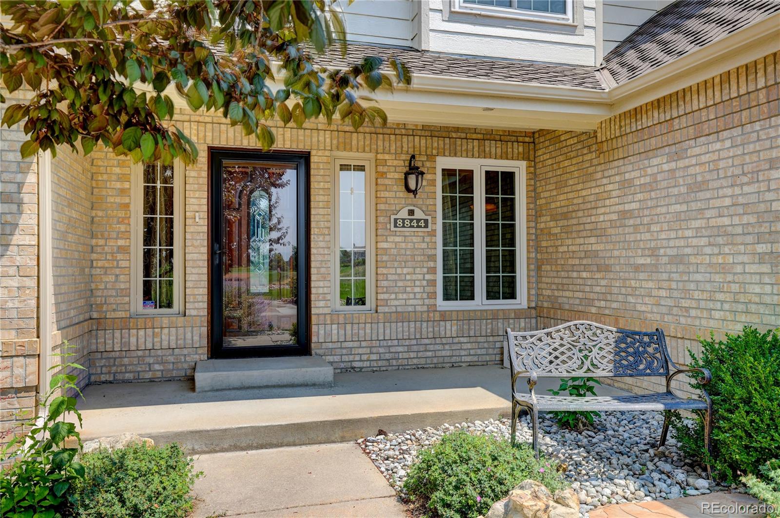 8844 South Forrest Drive Highlands Ranch, CO 80126 - Photo 3 of 40 a front view of a house with a garden