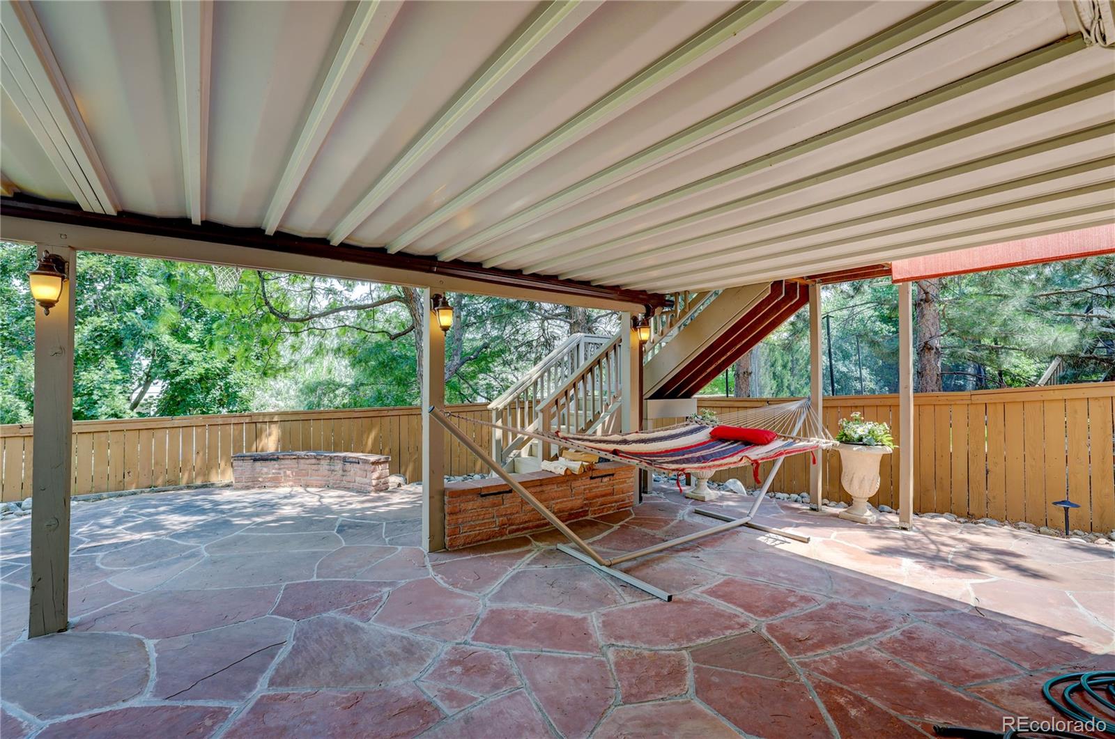 8844 South Forrest Drive Highlands Ranch, CO 80126 - Photo 33 of 40 a view of a patio with table and chairs under an umbrella
