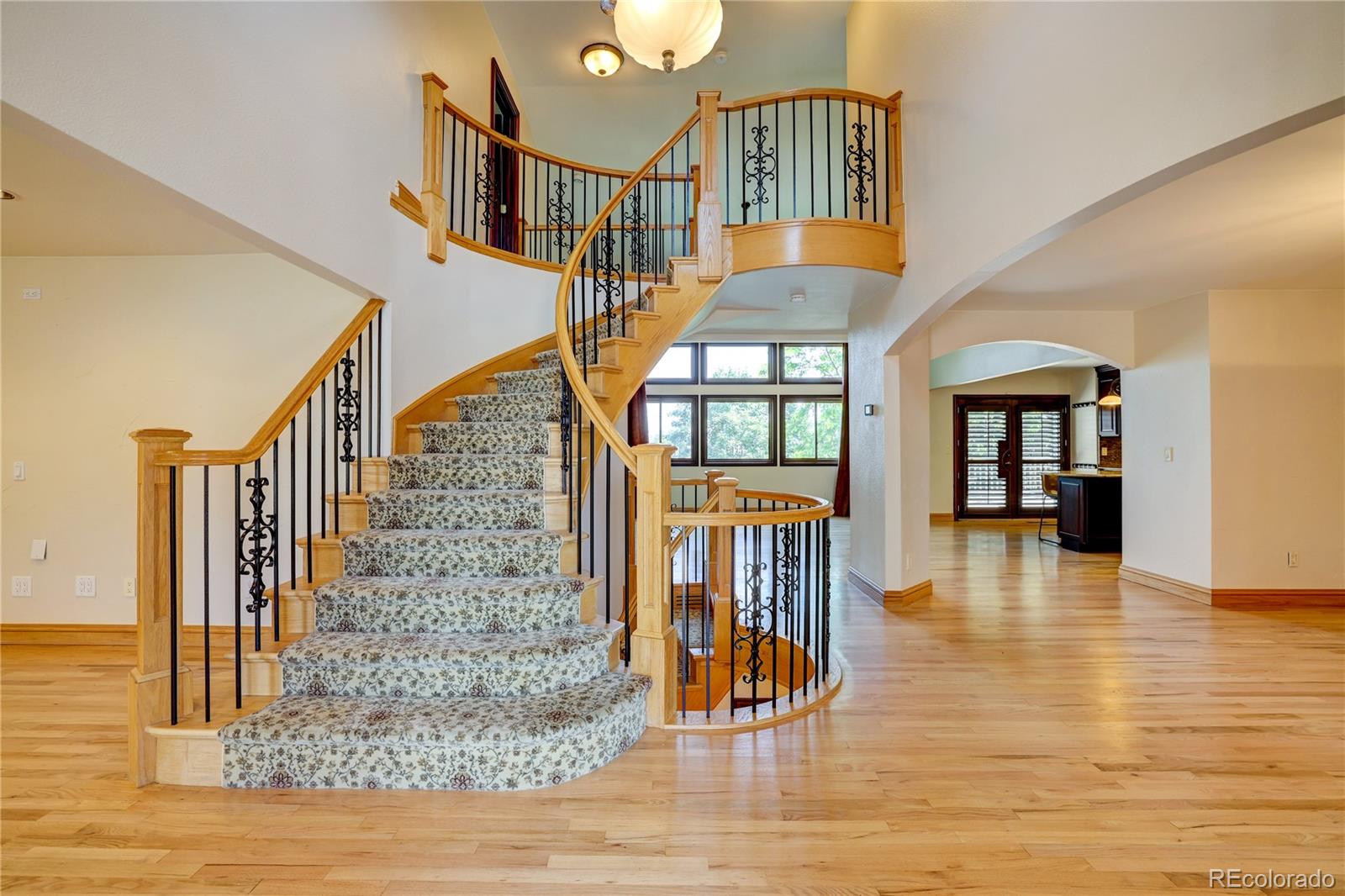 8844 South Forrest Drive Highlands Ranch, CO 80126 - Photo 4 of 40 a view of entryway and hall with wooden floor