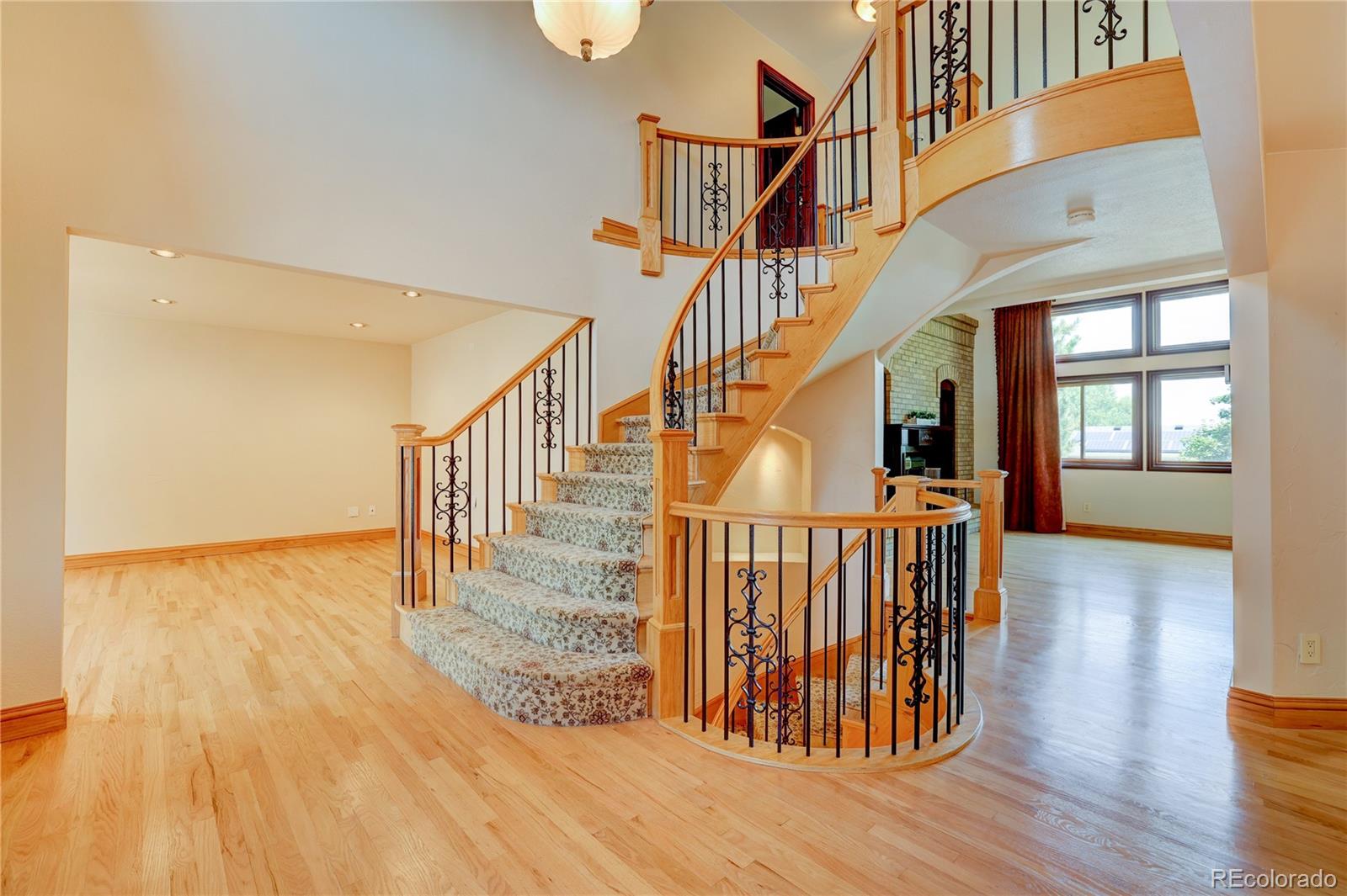 8844 South Forrest Drive Highlands Ranch, CO 80126 - Photo 5 of 40 a view of entryway and hall with wooden floor
