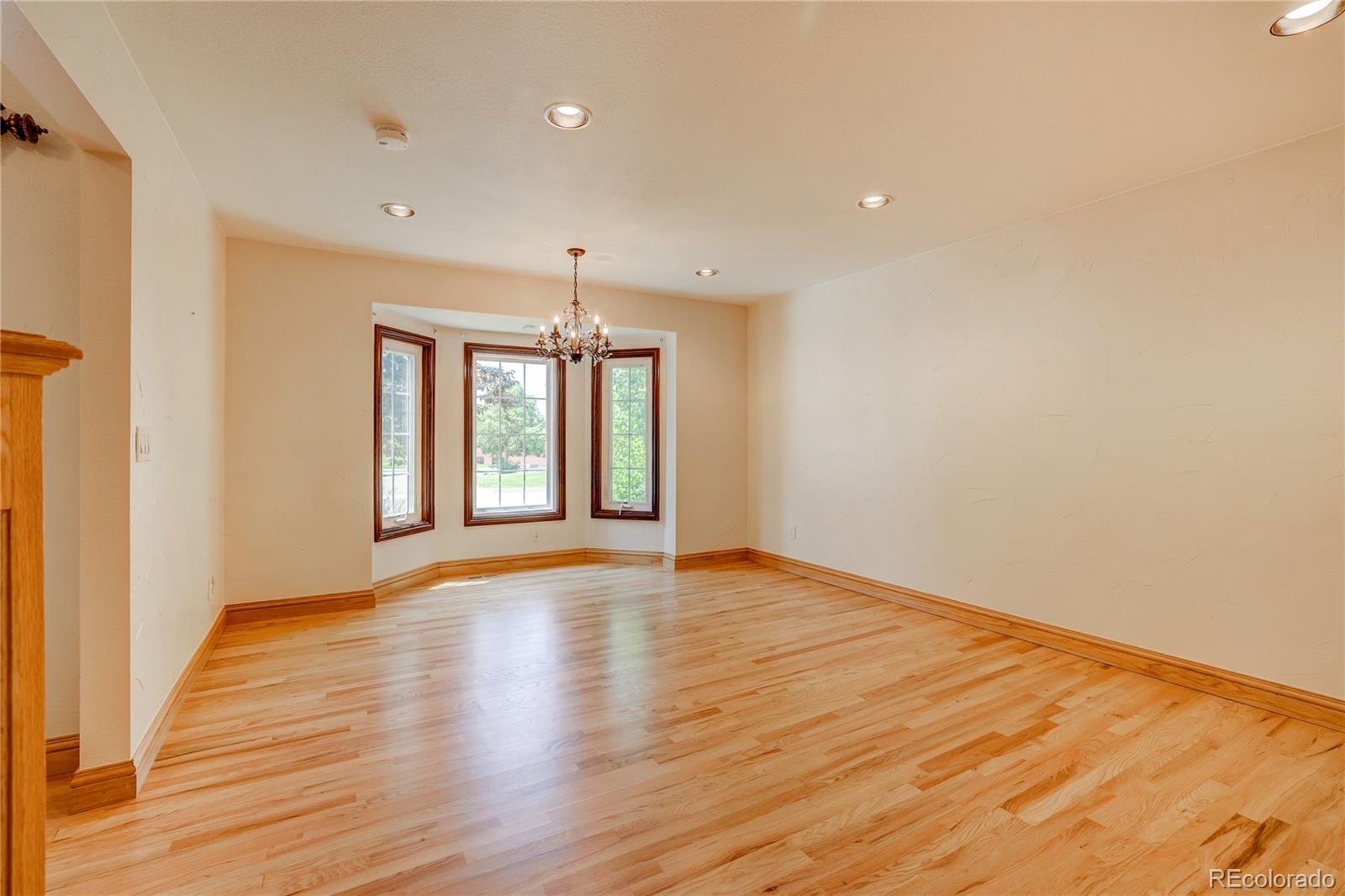 8844 South Forrest Drive Highlands Ranch, CO 80126 - Photo 7 of 40 a view of an empty room with wooden floor and a window