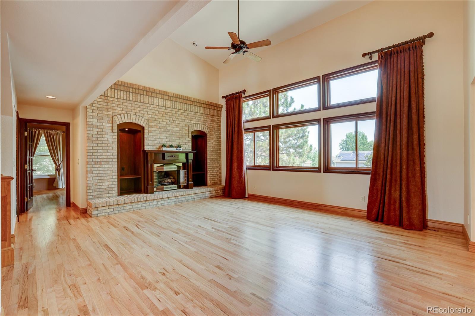 8844 South Forrest Drive Highlands Ranch, CO 80126 - Photo 9 of 40 a view of empty room with wooden floor and fan
